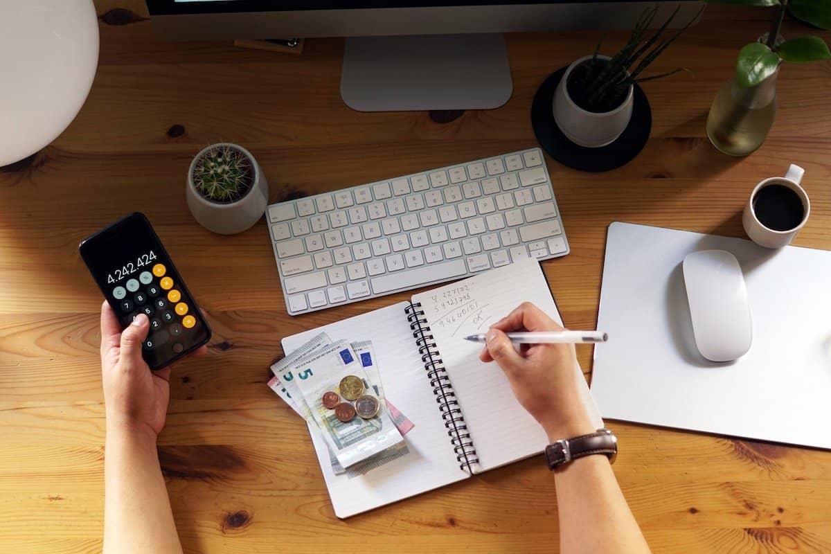 Home Loan Deposit Calculator | A depiction of a person working out sums on a calculator.