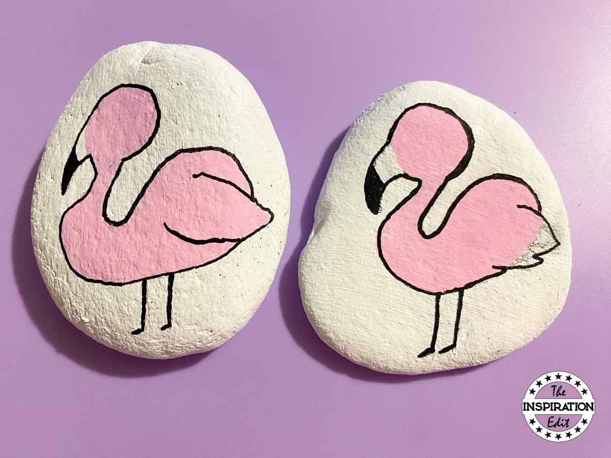 outline flamingo painted rock with black posca paint. 