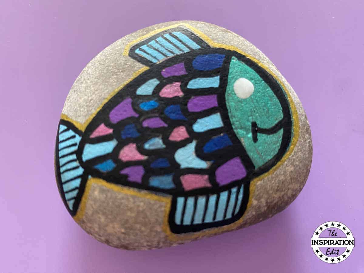 painting an eye onto a fish design. 