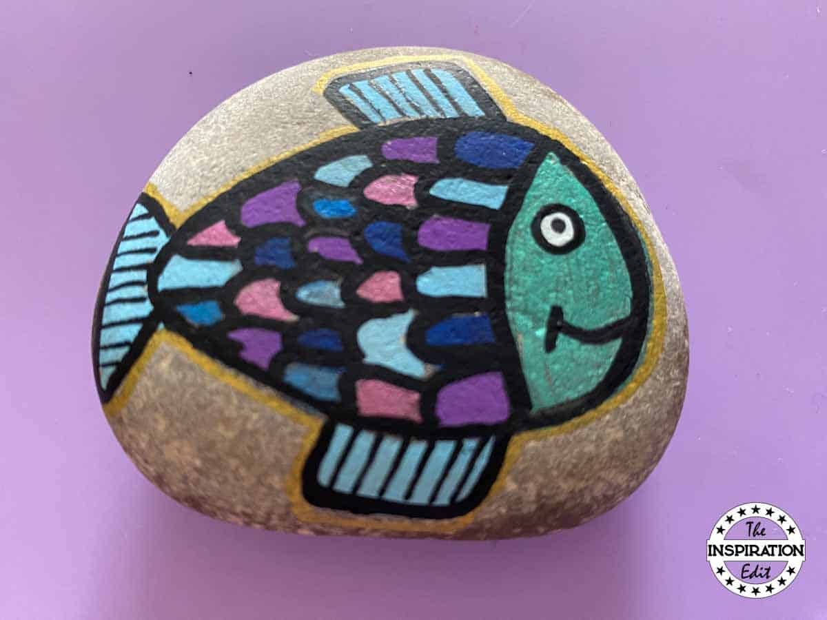 a fish painted on a rock. 