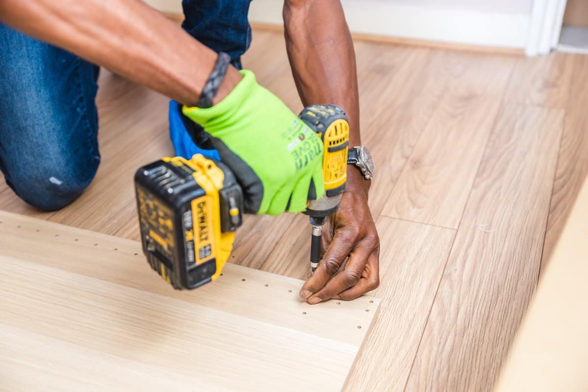 Items Every Handyman Needs | A Workman with a Cordless drill.