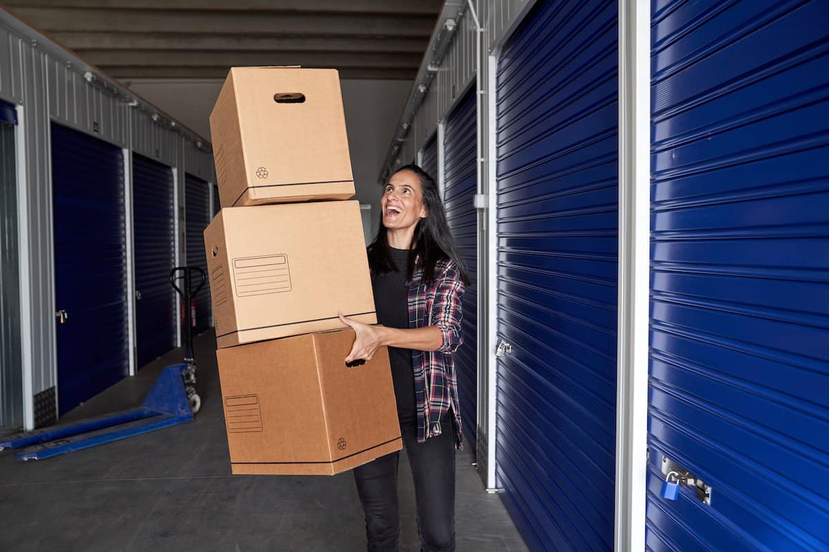 Local Residents Embrace Self-Storage | Woman carrying boxes in to Self Storage.