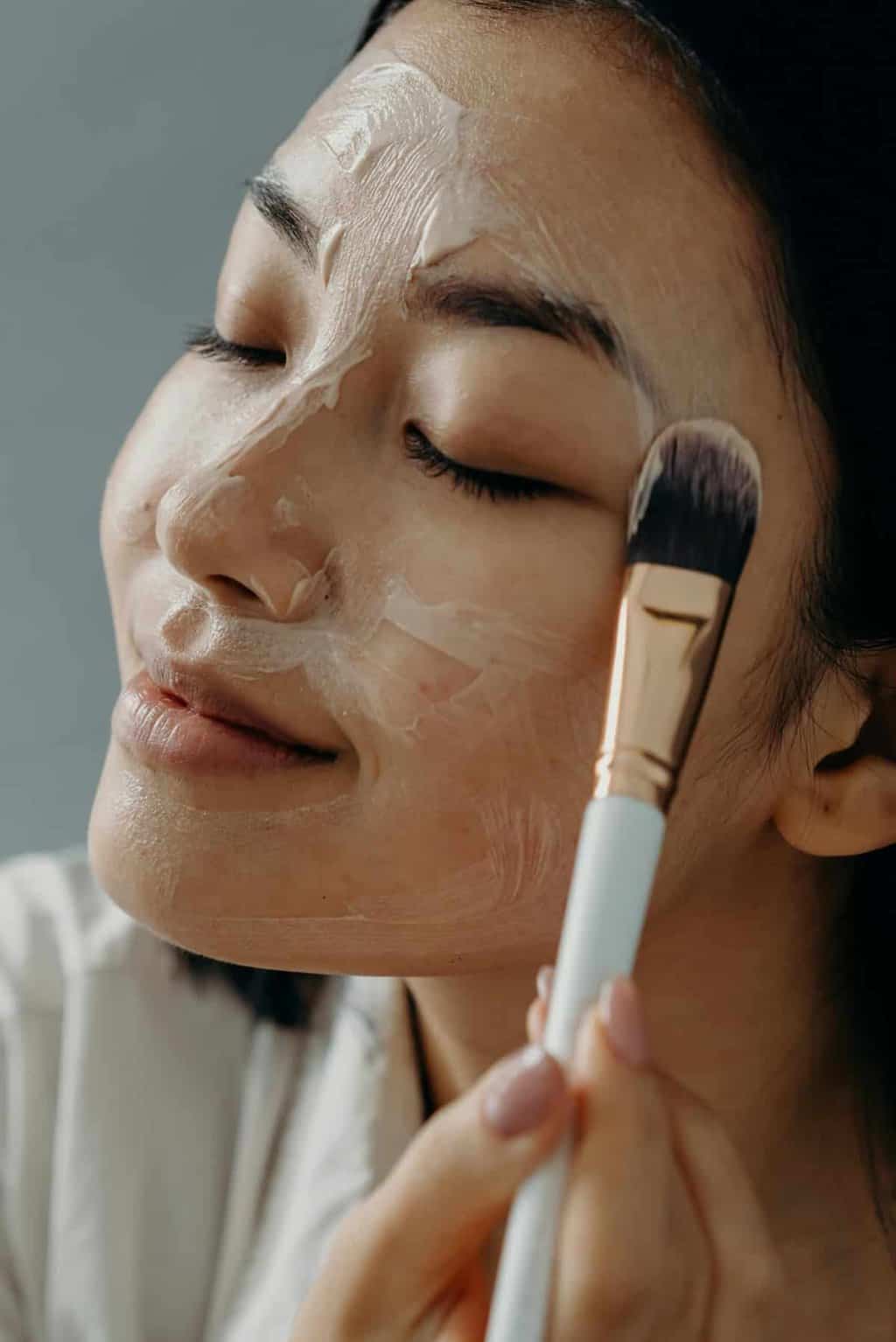 Why Women Are Redefining Beauty | Woman applying aging cream to face.