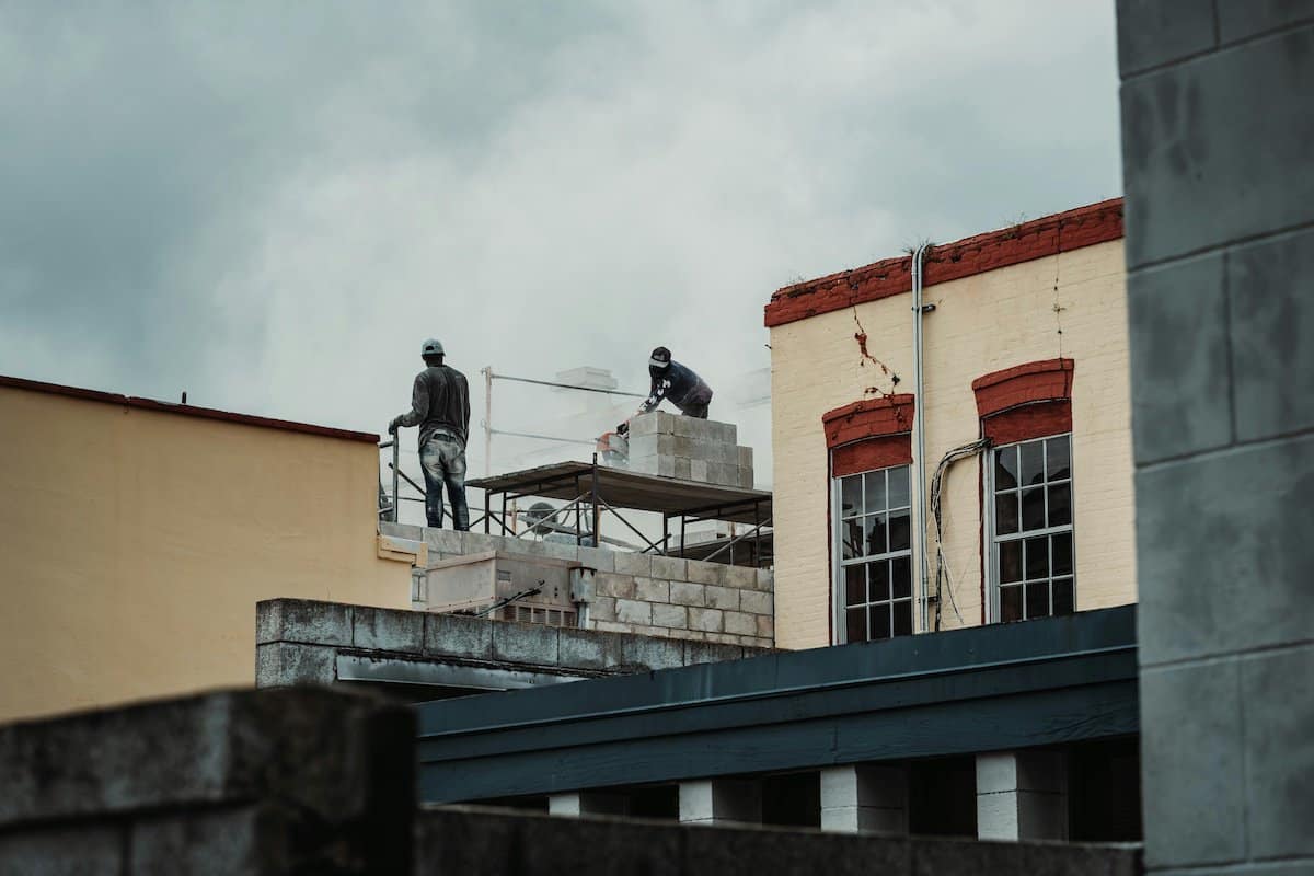 Protect Your Roof | Work men repairing a house roof.