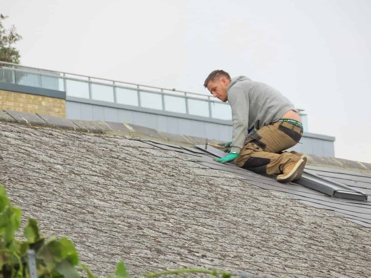 Protect Your Roof | Work men repairing a house roof.