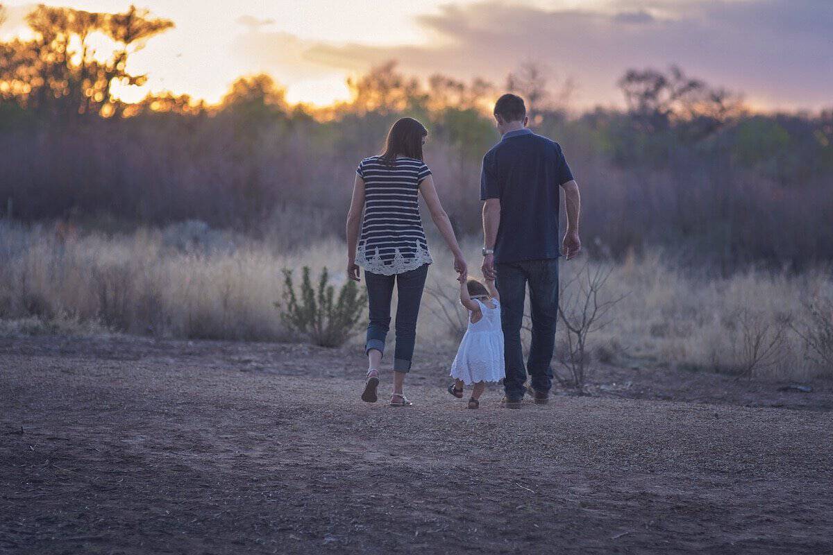 Strong Through Legal And Financial Struggles | Mother, Daughter and Father out for a walk.