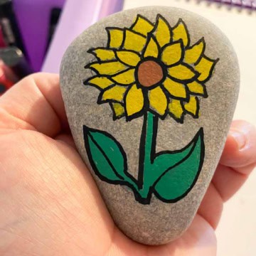Sunflower painted rock.