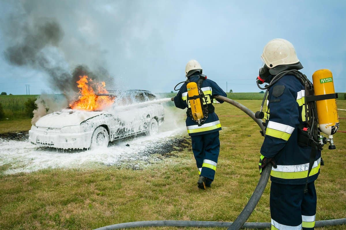 Truck Accidents | A Car on fire being extinguished by firemen.