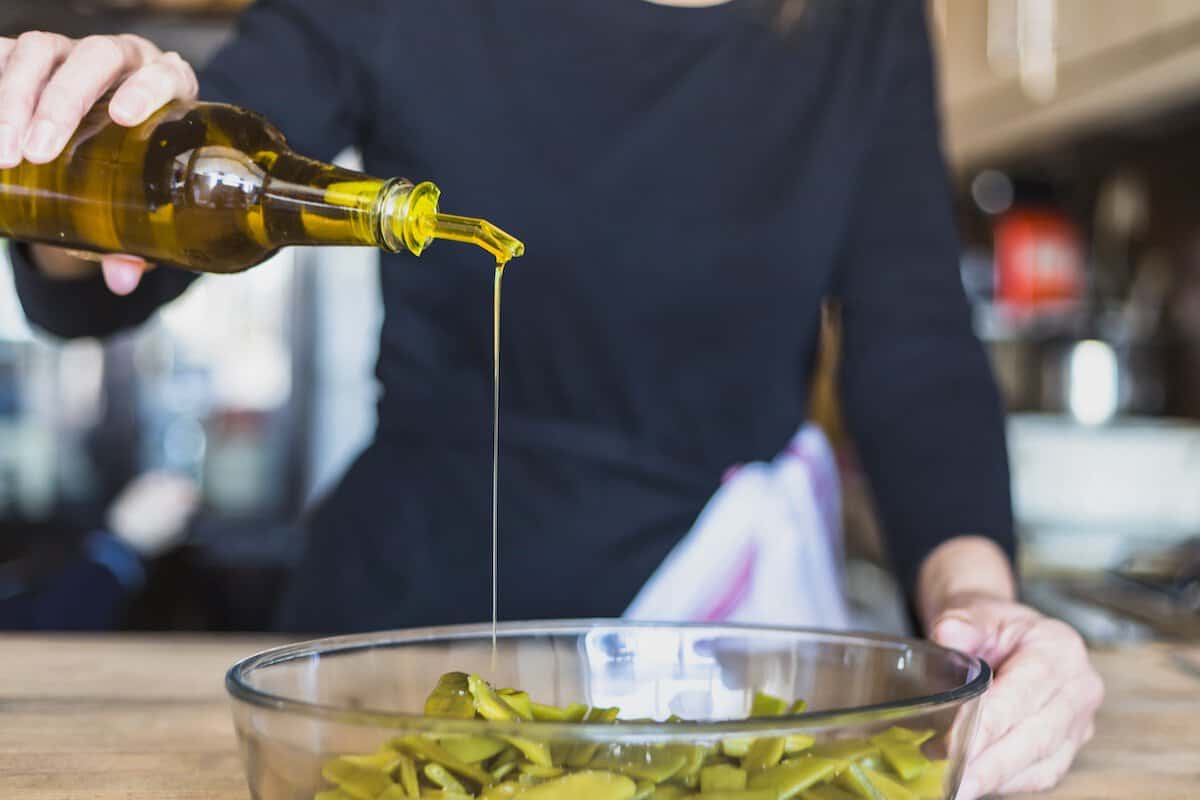 Truffle Oil | Woman pouring oil in to a bowl.
