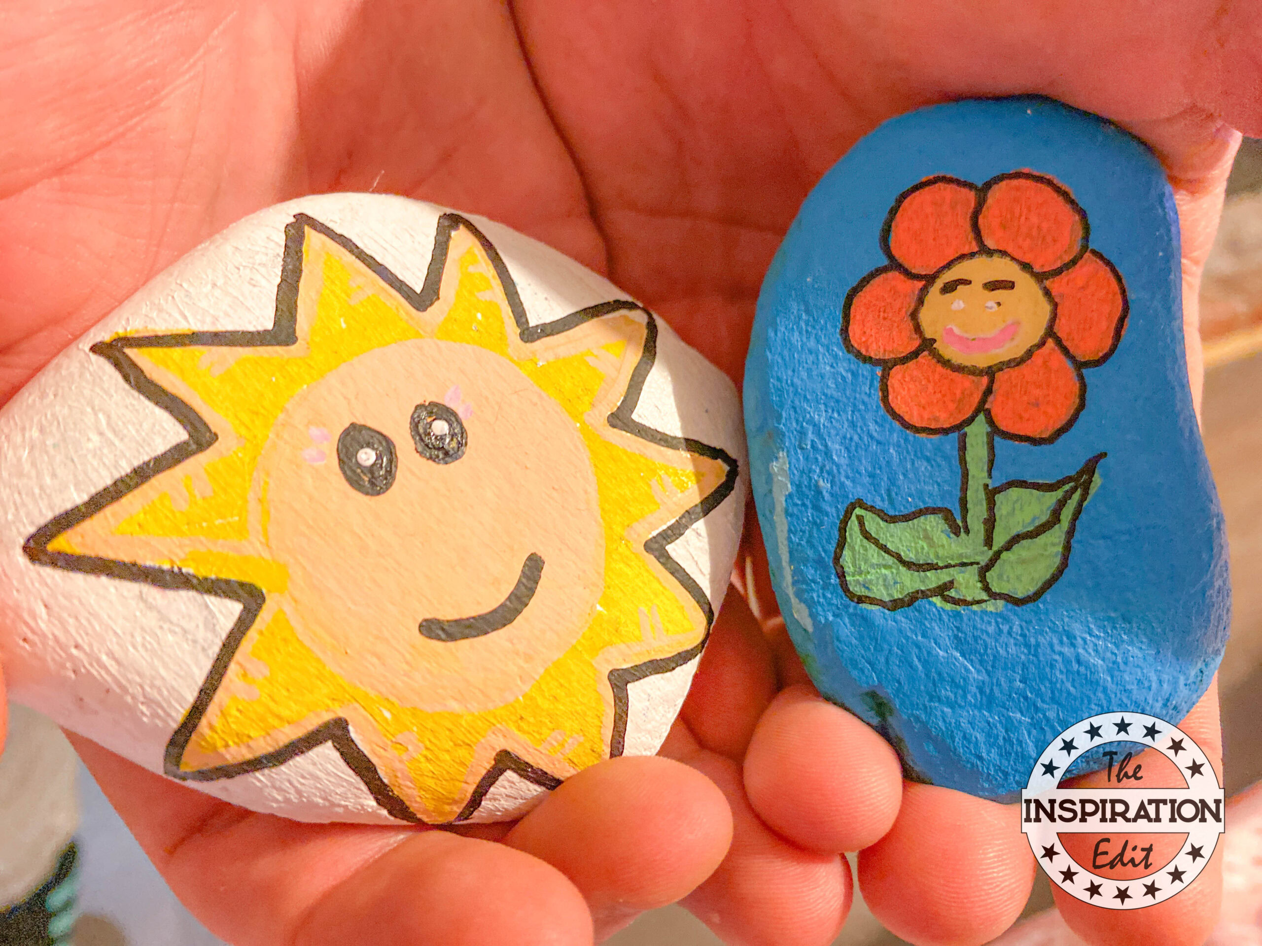 summer painted rocks. Sun and flower. 