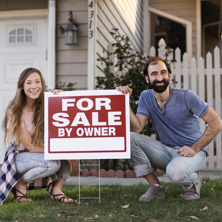 Home Sale Tactics | A couple putting up sign for selling their home.