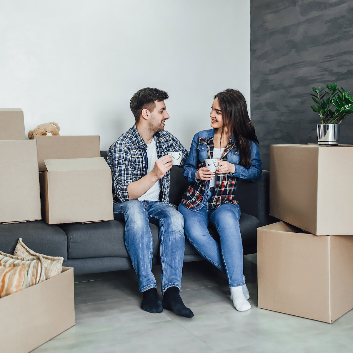 Sell your home easily | Couple with their property in Boxes ready to move.