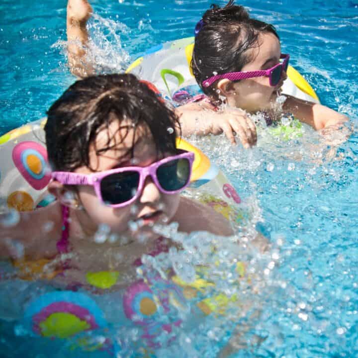 Swimming Classes Help Child Development | Two girls having fun a swimming pool.