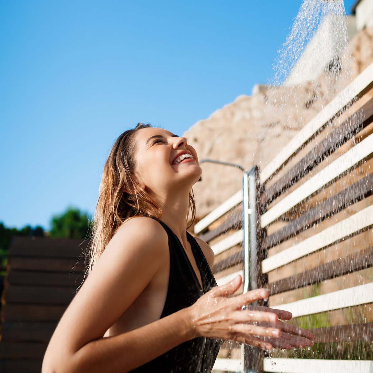 girl using a solar power hot water system.