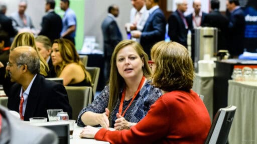 Two women networking at a convention in the George R Brown Convention Center in Downtown Houston