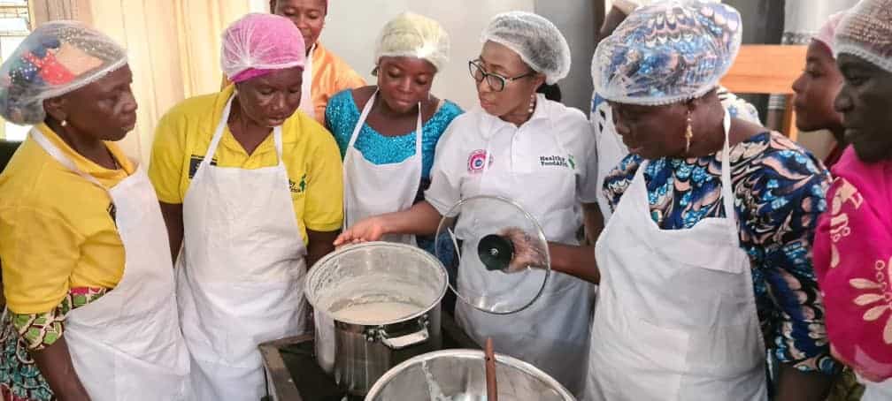 People gathered around cooking equipment