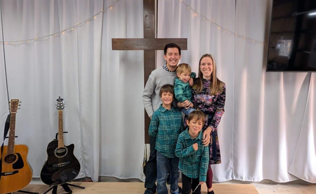 James and Rosie and their boys standing in the front of their church