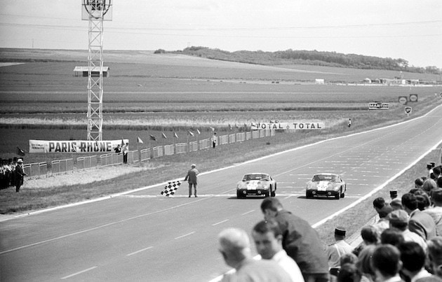 Reims 12 Hour Race, Reims, France, 1965. Two Shelby Cobra coupes cross the finish line together. 