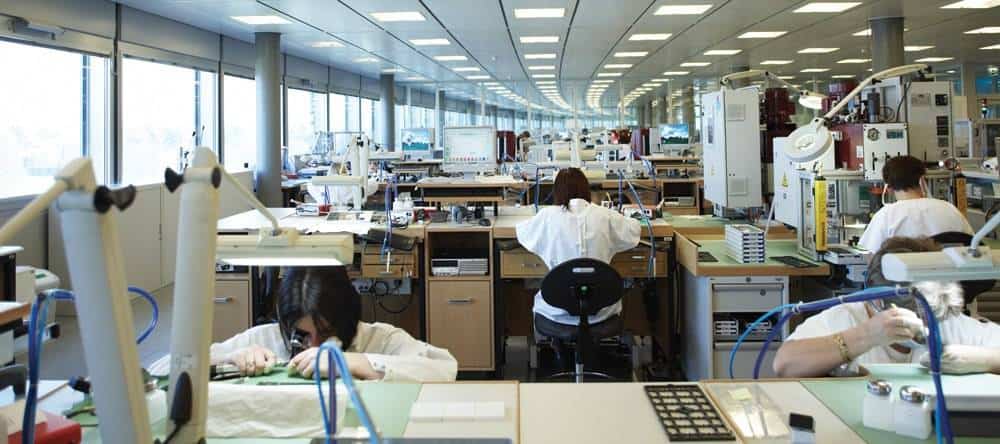 Watchmakers assembling dials at Rolex’s Chêne-Bourg site.