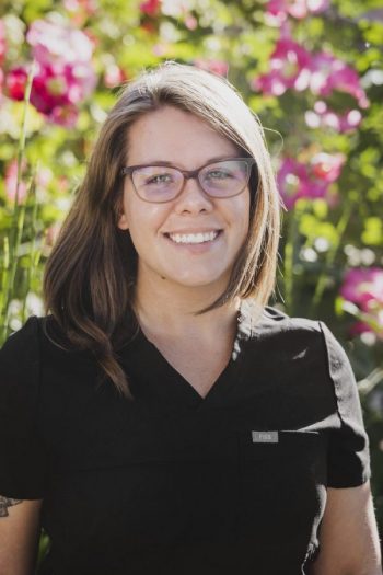 Headshot of a women with a black shirt and brown short hair standing outside | Hannah Schroeder