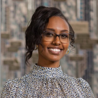 Headshot of a women in a patterned shirt | Alaa Gerais