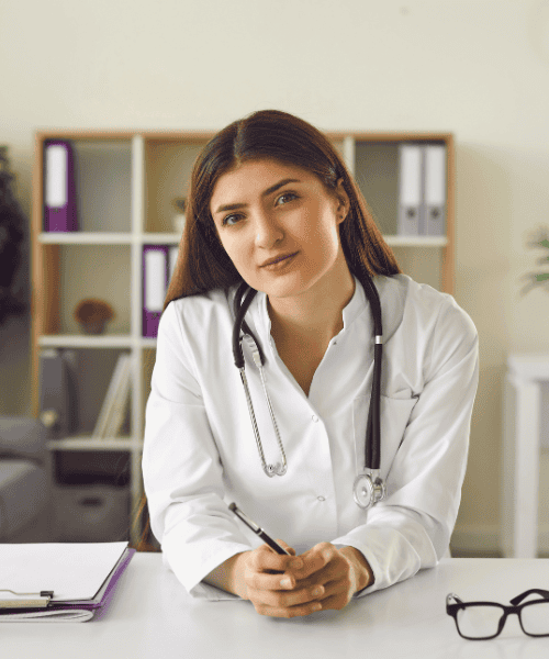 Naturopathic doctor discussing symptoms of chronic stress with a patient in a calm, supportive clinic setting