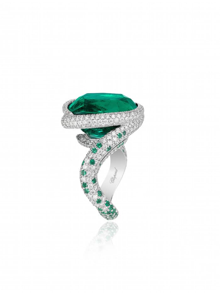 Red Carpet Ring in 18ct white gold featuring a 14.8cts cushion-shaped emerald and fully set with brilliant-cut diamonds and brilliant-cut emeralds