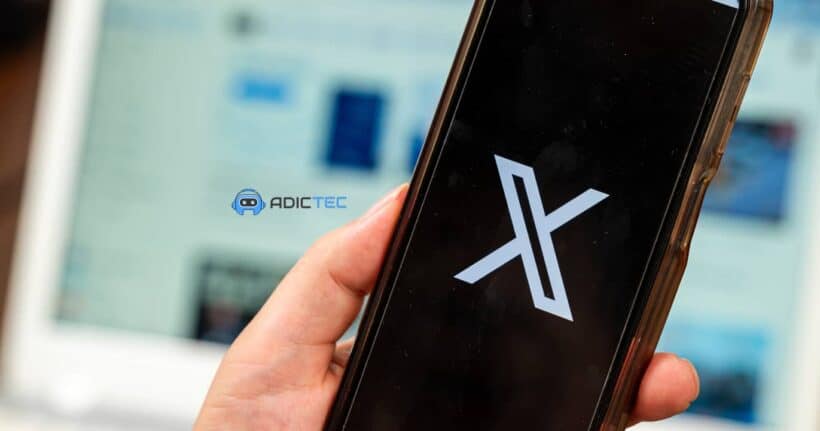 Una mano sosteniendo un teléfono móvil que muestra el logotipo de X (antes Twitter).