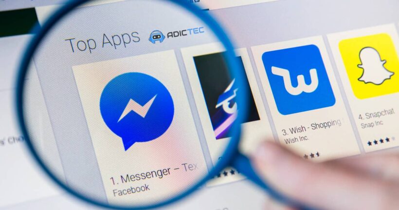 Una lupa enfoca en una pantalla que muestra una lista de aplicaciones, destacando la aplicación de Facebook Messenger.