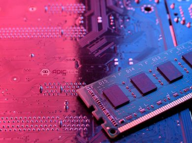 Un módulo de memoria RAM sobre una placa base de ordenador iluminada con luz rosa y azul.