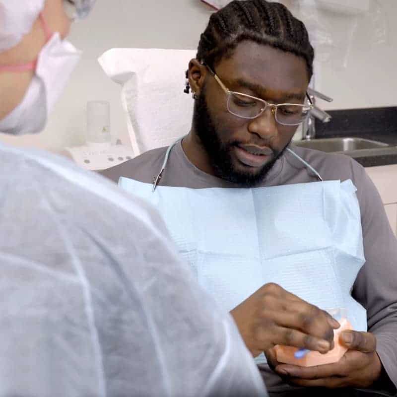 Close up shot of male dental patient in dentist's chair