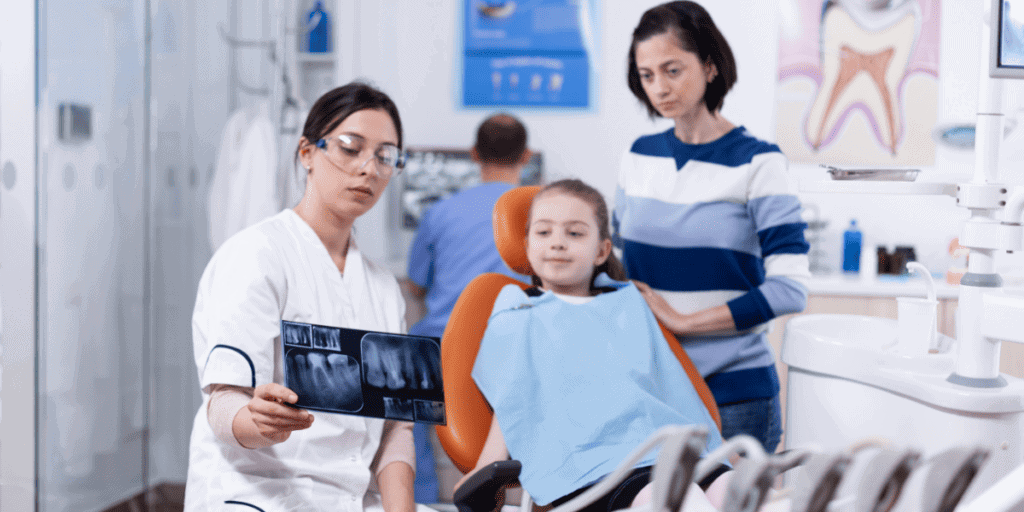 Dentist showing x-ray result to patient