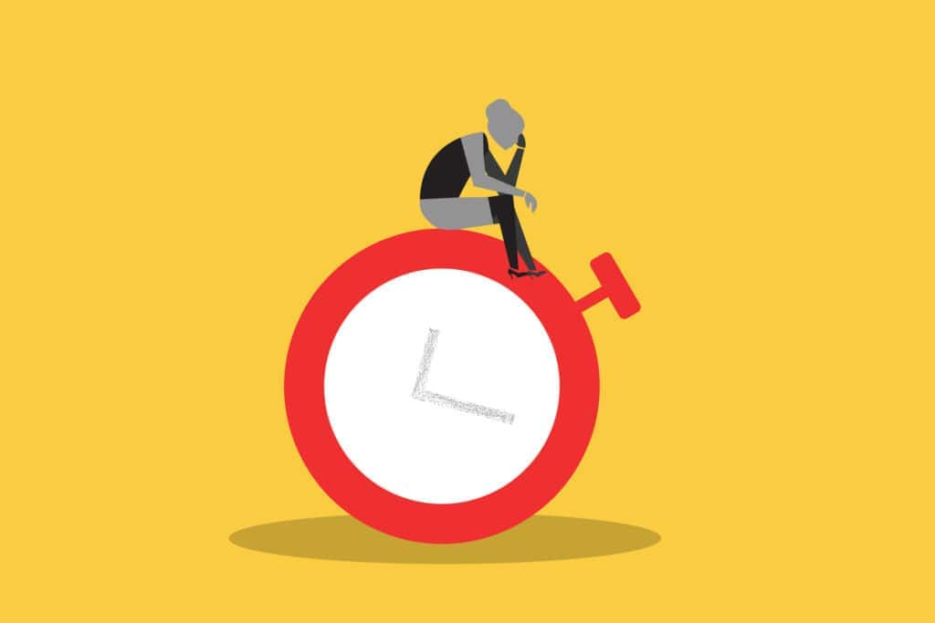 A flat graphic illustration of a dejected figure slumped atop a large red clock on a yellow background, representing the time and energy lost to a difficult client relationship.