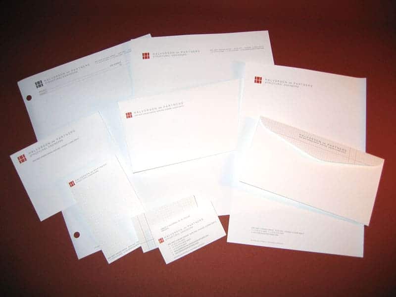 Halvorson and Partners branded stationery including letterhead, envelopes, business cards, and grid paper.