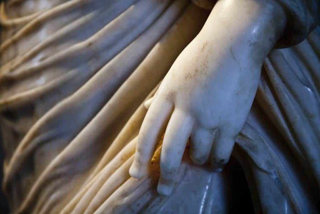Close up of stone sculpture, detail of an elegant hand.