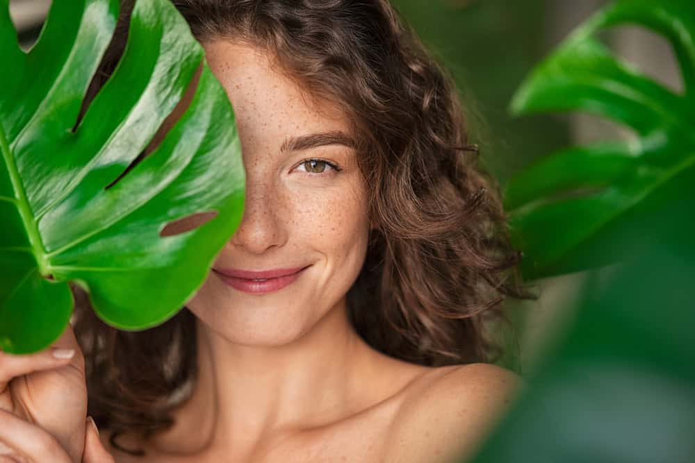 Close,Up,Face,Of,Beautiful,Young,Woman,Covering,Her,Face