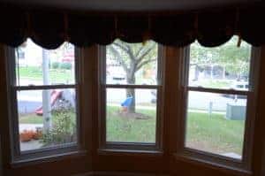 A clear view through three spacious bay windows reveals a tree-lined street, lush grass, and a sunny neighborhood sidewalk—reflecting Bell Brothers’ commitment to brightening homes across Northern California. With our No Surprise Guarantee, background-checked technicians, and upfront pricing, families rely on us for trusted service and peace of mind in every community we serve.