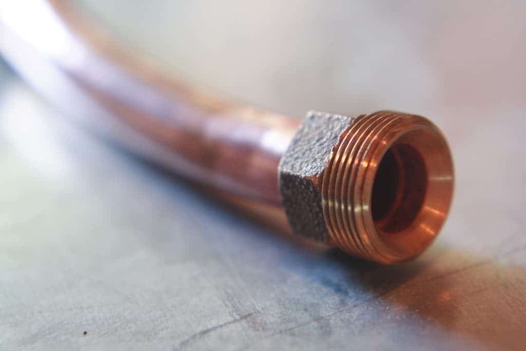A close-up of a copper pipe with a threaded fitting, representing Bell Brothers’ commitment to quality plumbing service. Our trusted, background-checked technicians provide honest assessments with our exclusive No Surprise Guarantee—meaning upfront pricing and no hidden fees. Proudly serving Northern California communities, we’re dedicated to delivering reliable solutions you can trust.