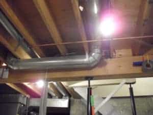 A well-lit basement features exposed wooden ceiling beams and visible metal ductwork. Bell Brothers’ trusted, background-checked technicians provide expert service in spaces like this throughout Northern California—always with our No Surprise Guarantee, upfront pricing, and the reputation homeowners trust.