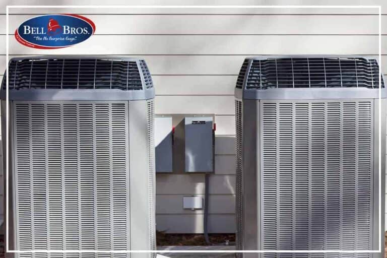 Two outdoor air conditioning units sit beside a beige siding wall, with electrical boxes in between. The Bell Bros. logo in the top left highlights our No Surprise Guarantee, background-checked technicians, and honest upfront pricing—the trusted choice for HVAC service in Northern California communities.