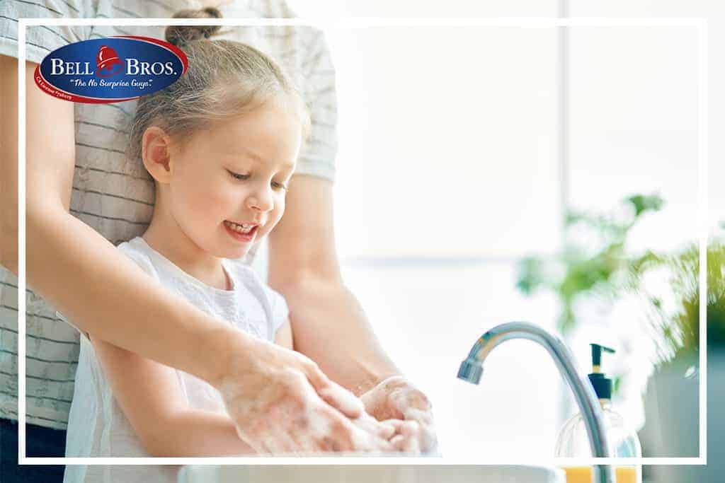 A caring adult helps a young girl wash her hands at a sparkling sink, highlighting Bell Brothers’ commitment to dependable service you can trust. The Bell Bros. logo in the corner represents our No Surprise Guarantee, background-checked technicians, and honest upfront pricing—values that have earned us a strong reputation in communities throughout Northern California.