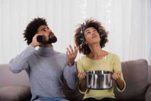 A worried couple sits on their couch as water leaks from the ceiling—one person calls for help while the other catches water in a pot. With Bell Brothers, you can count on a trusted team of background-checked technicians, clear upfront pricing, and our No Surprise Guarantee. We're proud to serve Northern California communities with reliable service you can depend on.