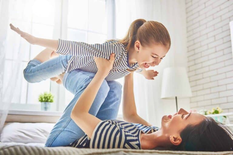 A joyful parent plays with their smiling child in a bright, sunlit room—capturing the warmth, comfort, and peace of mind Bell Brothers brings to homes across Northern California. Trust our background-checked technicians for expert service backed by up-front pricing and our No Surprise Guarantee—the reason so many local families rely on Bell Brothers.