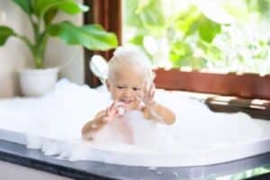 A young child with blonde hair enjoys playing with bubbles in a bathtub by a sunlit window, surrounded by green plants. At Bell Brothers, we’re proud to help families across Northern California enjoy safe, comfortable homes—backed by our No Surprise Guarantee, background-checked technicians, and upfront pricing you can trust. Discover why so many local communities rely on our team for honest service and peace of mind.