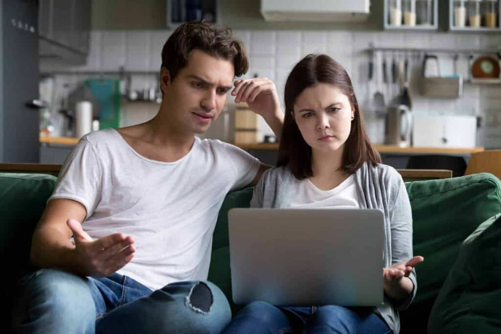A couple sits together on their living room couch, looking at a laptop with concerned expressions. At Bell Brothers, we understand that home service surprises can be stressful. That’s why our trusted technicians—background-checked for your peace of mind—always provide clear, upfront pricing as part of our No Surprise Guarantee. Proudly serving Northern California communities, we’re dedicated to delivering reliable comfort you can count on.