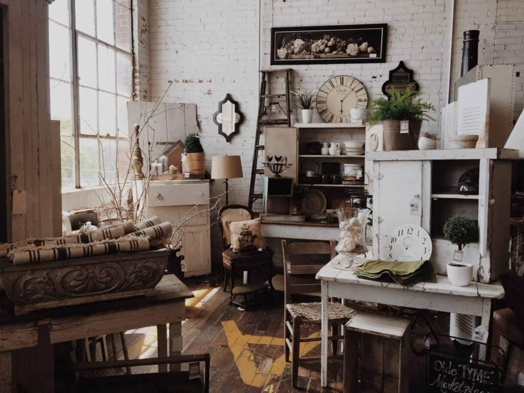 A welcoming showroom featuring vintage-style furniture, cozy stacked linens, potted plants, decorative clocks, and a variety of home décor neatly arranged throughout. Just like our inviting spaces, Bell Brothers’ trusted technicians bring comfort to Northern California homes—always background-checked for your peace of mind. With our No Surprise Guarantee and upfront pricing, you can expect honest service backed by the strong reputation we’ve built in communities across the region.