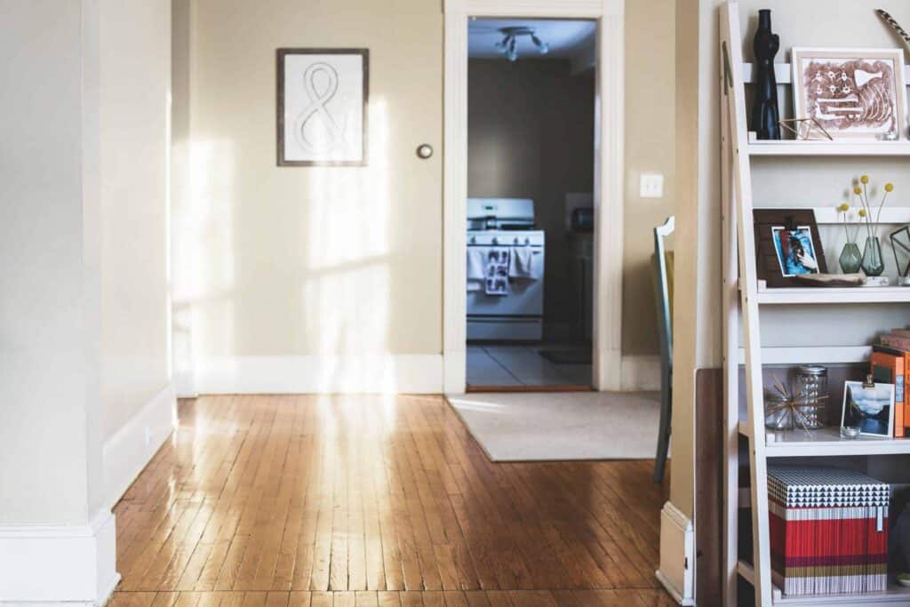 A welcoming, sunlit room with polished wooden floors and a neatly arranged white bookshelf, highlighting the inviting atmosphere Bell Brothers brings to Northern California homes. With our No Surprise Guarantee, thoroughly background-checked technicians, and honest upfront pricing, you can trust Bell Brothers—proudly serving your community with reliable service and a strong reputation.