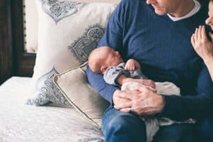 A trusted Bell Brothers technician ensures comfort and peace of mind for a Northern California family—an adult gently cradles a sleeping newborn on their lap as another supportive hand rests on their shoulder. With our No Surprise Guarantee, background-checked professionals, and straightforward upfront pricing, families across the region count on Bell Brothers for reliable service they can trust.