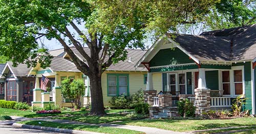 Image: a suburban block with a row of historic homes.