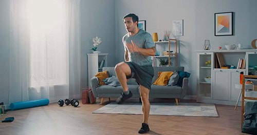 Image: a man working out in his well ventilated home.